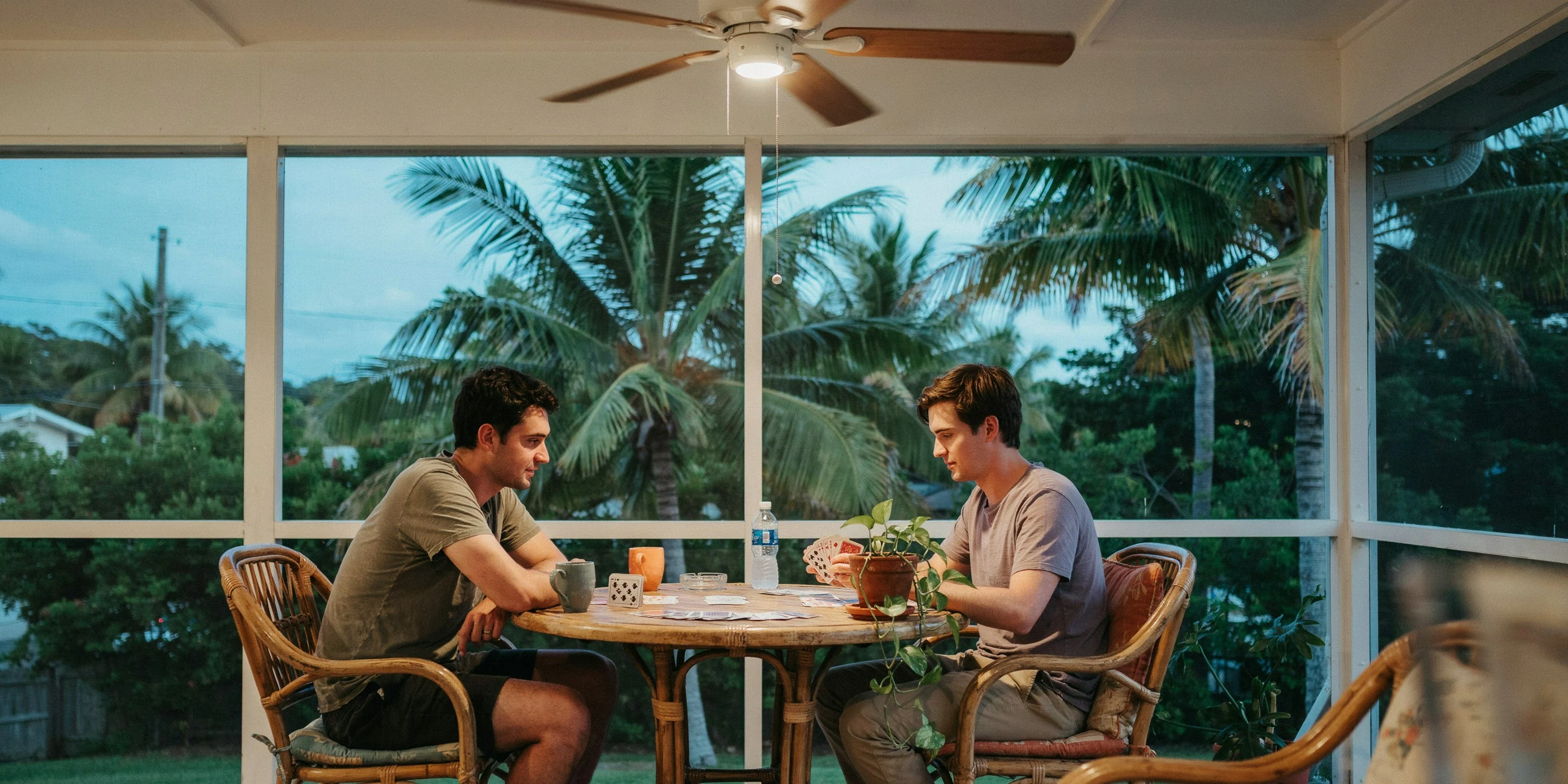 Neighbors playing cards on a screened lanai in Lakeridge Falls, Sarasota, FL
