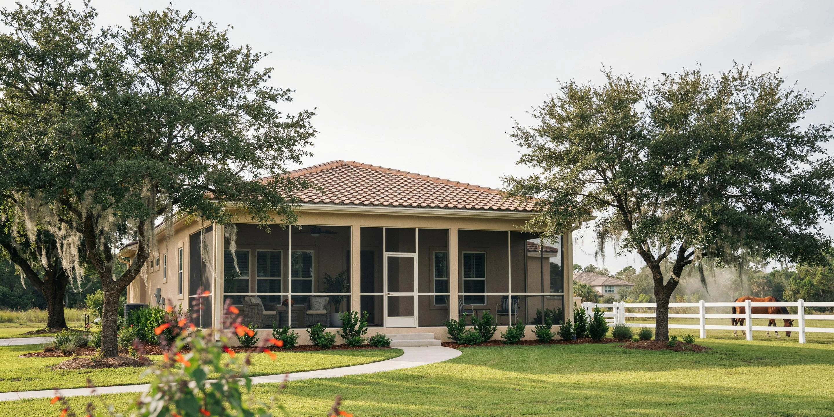 Ranch home with screened porch near a pasture fence in Tallevast, FL